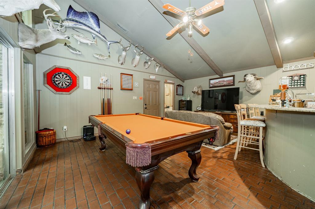 9511 Fallbrook Drive Dallas, TX 75243 - Photo 18 of 40 a living room with a table tennis table and a chairs