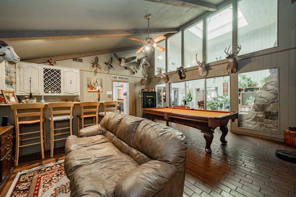 9511 Fallbrook Drive Dallas, TX 75243 - Photo 19 of 40 a living room with furniture a bed and a large window