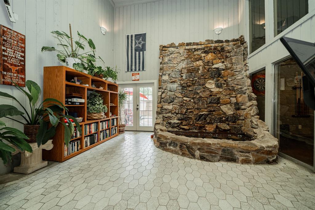 9511 Fallbrook Drive Dallas, TX 75243 - Photo 23 of 40 a view of front door and yard with wooden floor