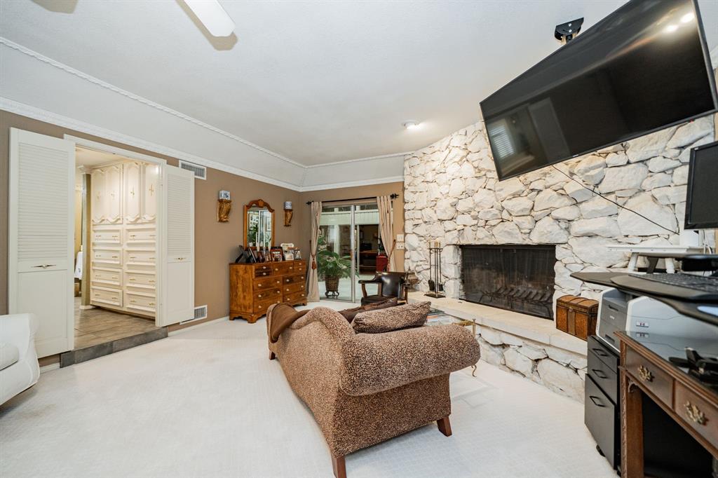 9511 Fallbrook Drive Dallas, TX 75243 - Photo 24 of 40 a living room with furniture a fireplace and a flat screen tv