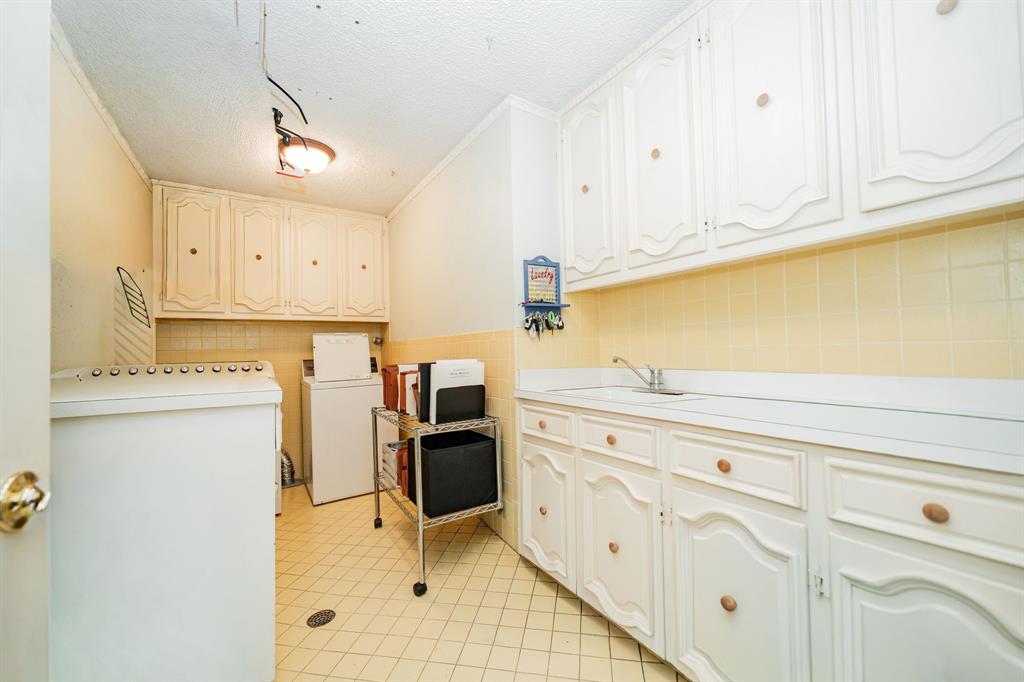 9511 Fallbrook Drive Dallas, TX 75243 - Photo 31 of 40 a kitchen with granite countertop white cabinets stainless steel appliances and sink