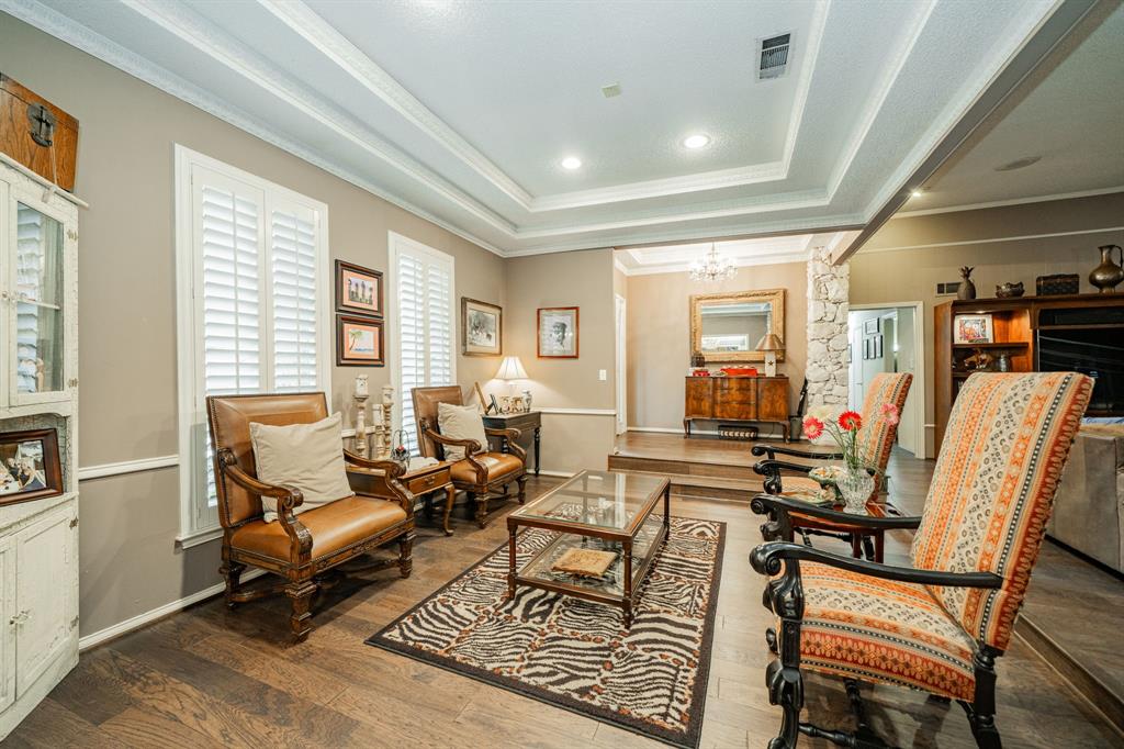 9511 Fallbrook Drive Dallas, TX 75243 - Photo 4 of 40 a living room with furniture a wooden floor and next to a window
