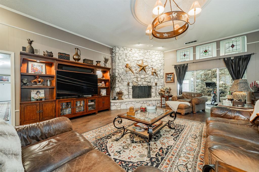 9511 Fallbrook Drive Dallas, TX 75243 - Photo 6 of 40 a living room with furniture a flat screen tv and a fireplace