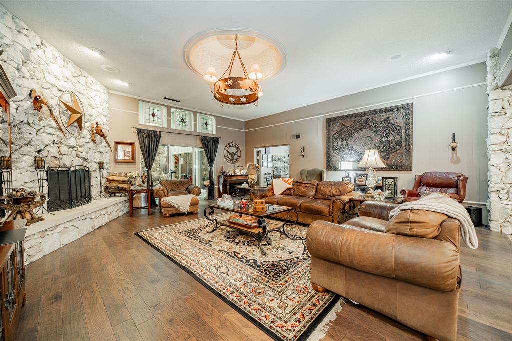 9511 Fallbrook Drive Dallas, TX 75243 - Photo 7 of 40 a living room with furniture a fireplace and a large window