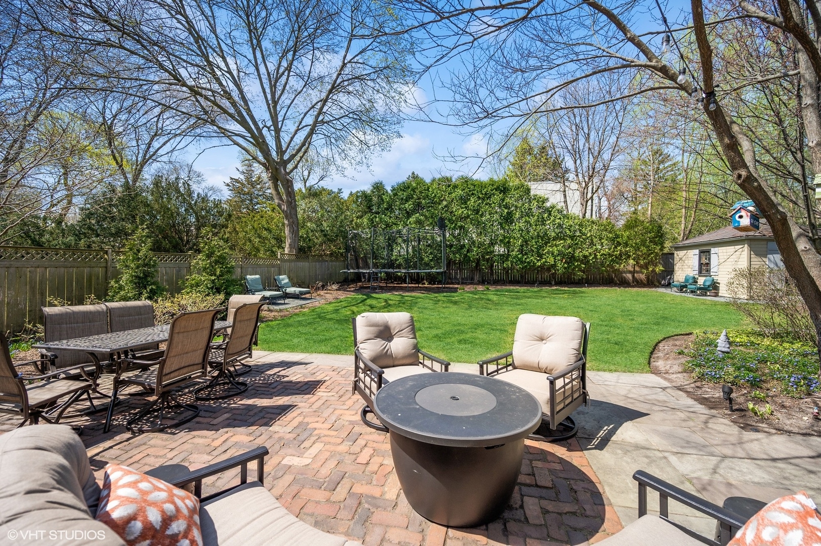 348 Sterling Road Kenilworth, IL 60043 - Photo 61 of 67 a view of a patio with table and chairs potted plants and a large tree