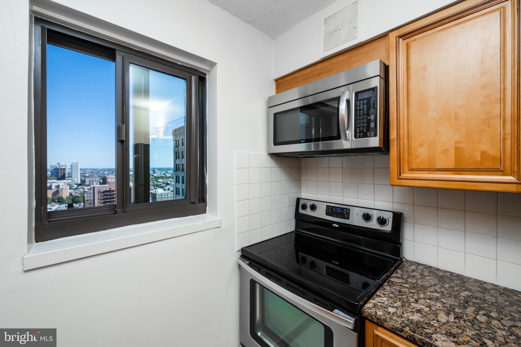 1420 Locust Street, Unit 24R Philadelphia, PA 19102 - Photo 13 of 31 a kitchen with a stove and a microwave