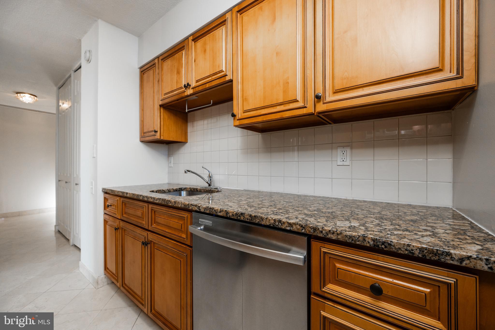 1420 Locust Street, Unit 24R Philadelphia, PA 19102 - Photo 14 of 31 a kitchen with stainless steel appliances granite countertop a sink and cabinets