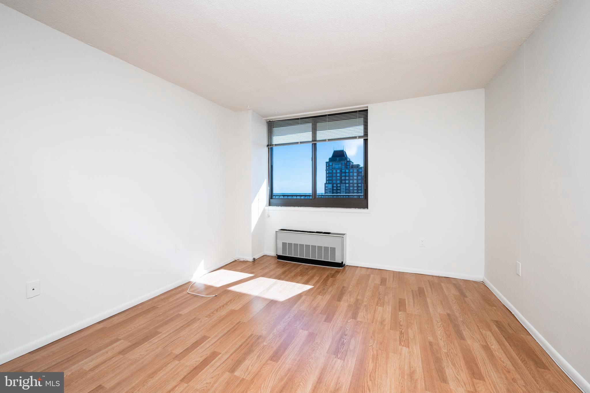 1420 Locust Street, Unit 24R Philadelphia, PA 19102 - Photo 17 of 31 a view of a room with wooden floor and white walls