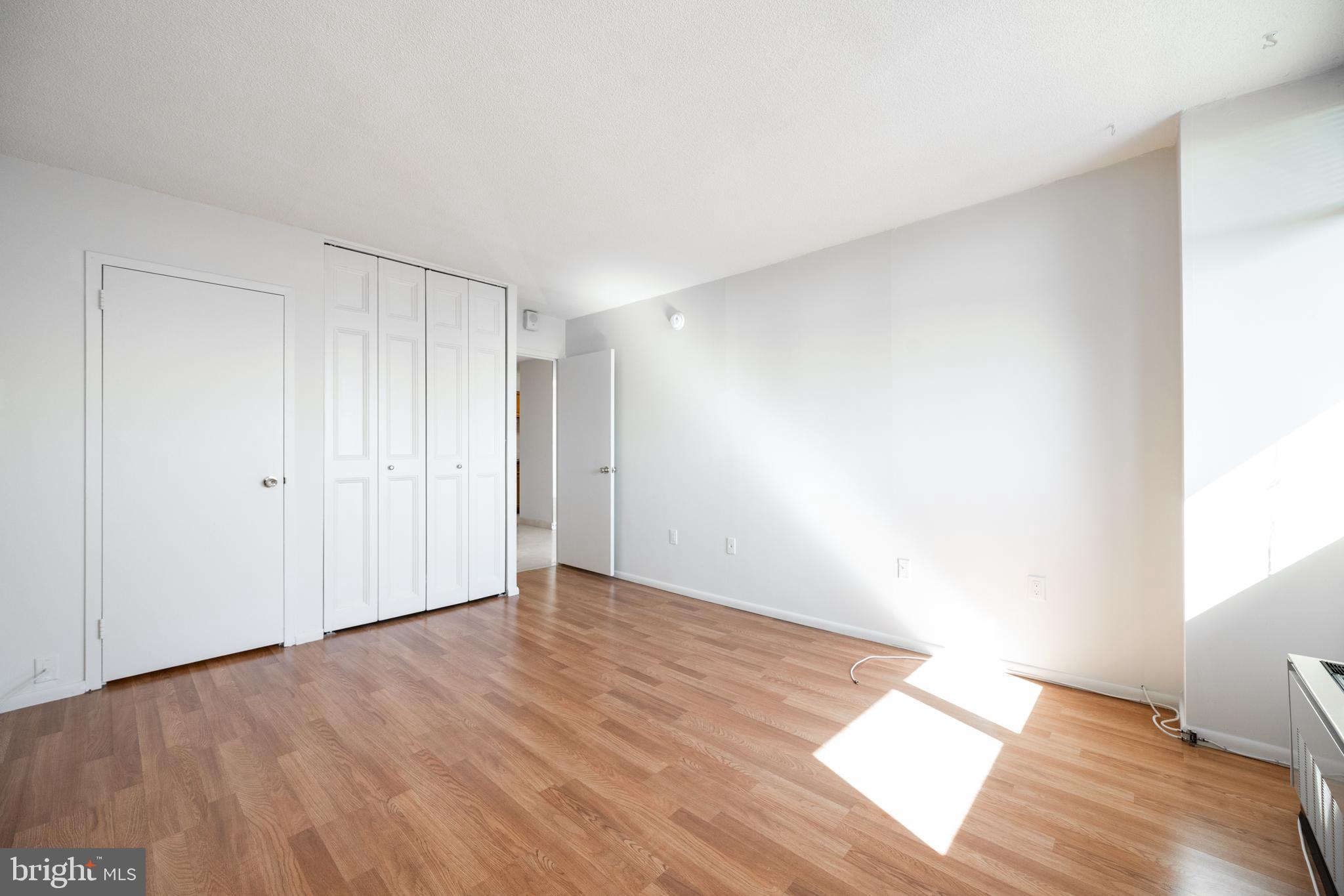 1420 Locust Street, Unit 24R Philadelphia, PA 19102 - Photo 18 of 31 a view of an empty room and wooden floor