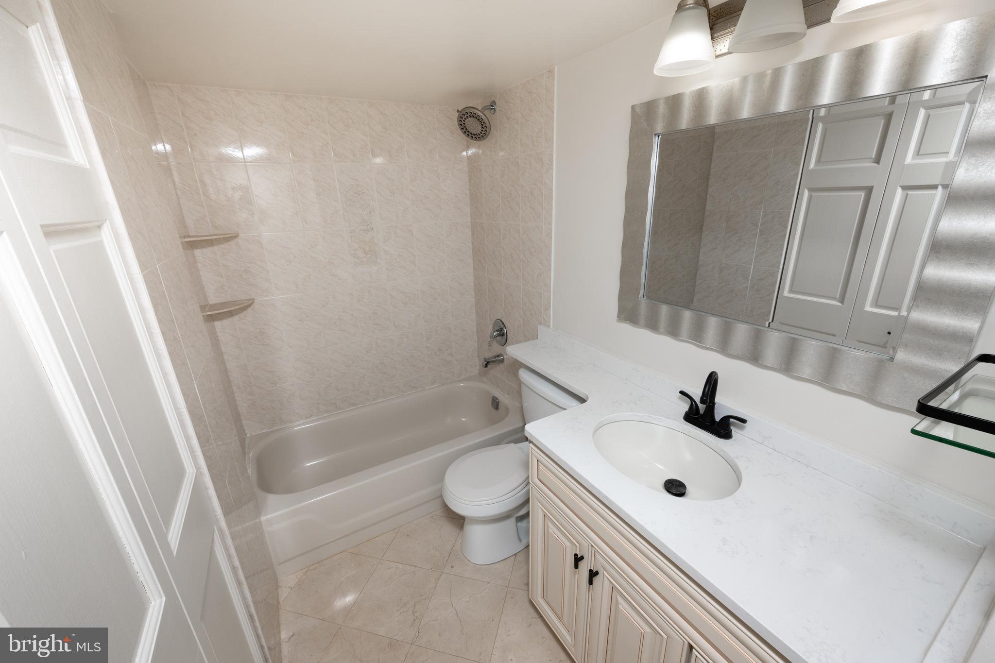 1420 Locust Street, Unit 24R Philadelphia, PA 19102 - Photo 20 of 31 a bathroom with a sink a toilet and shower