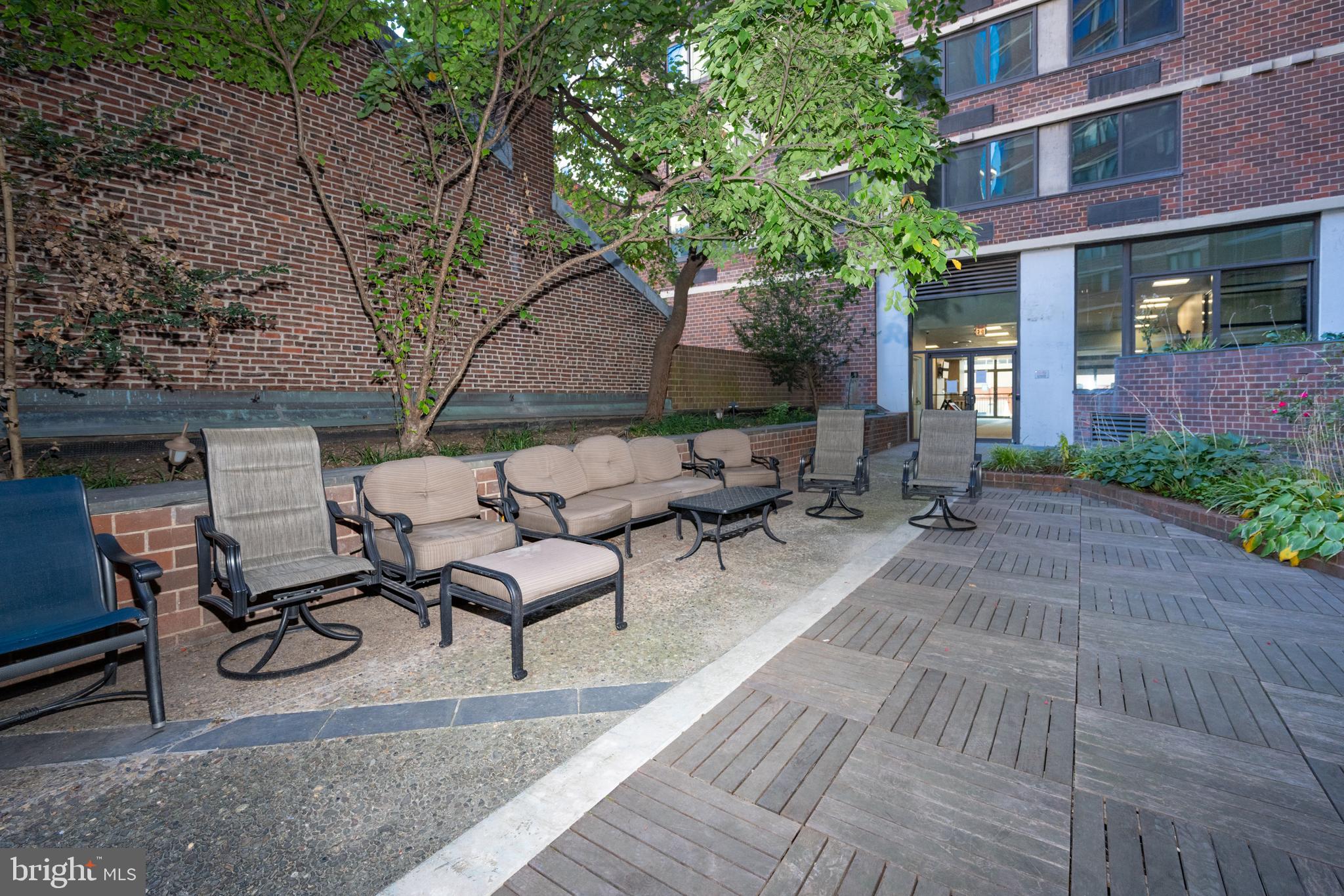1420 Locust Street, Unit 24R Philadelphia, PA 19102 - Photo 27 of 31 a view of backyard with furniture and a large tree