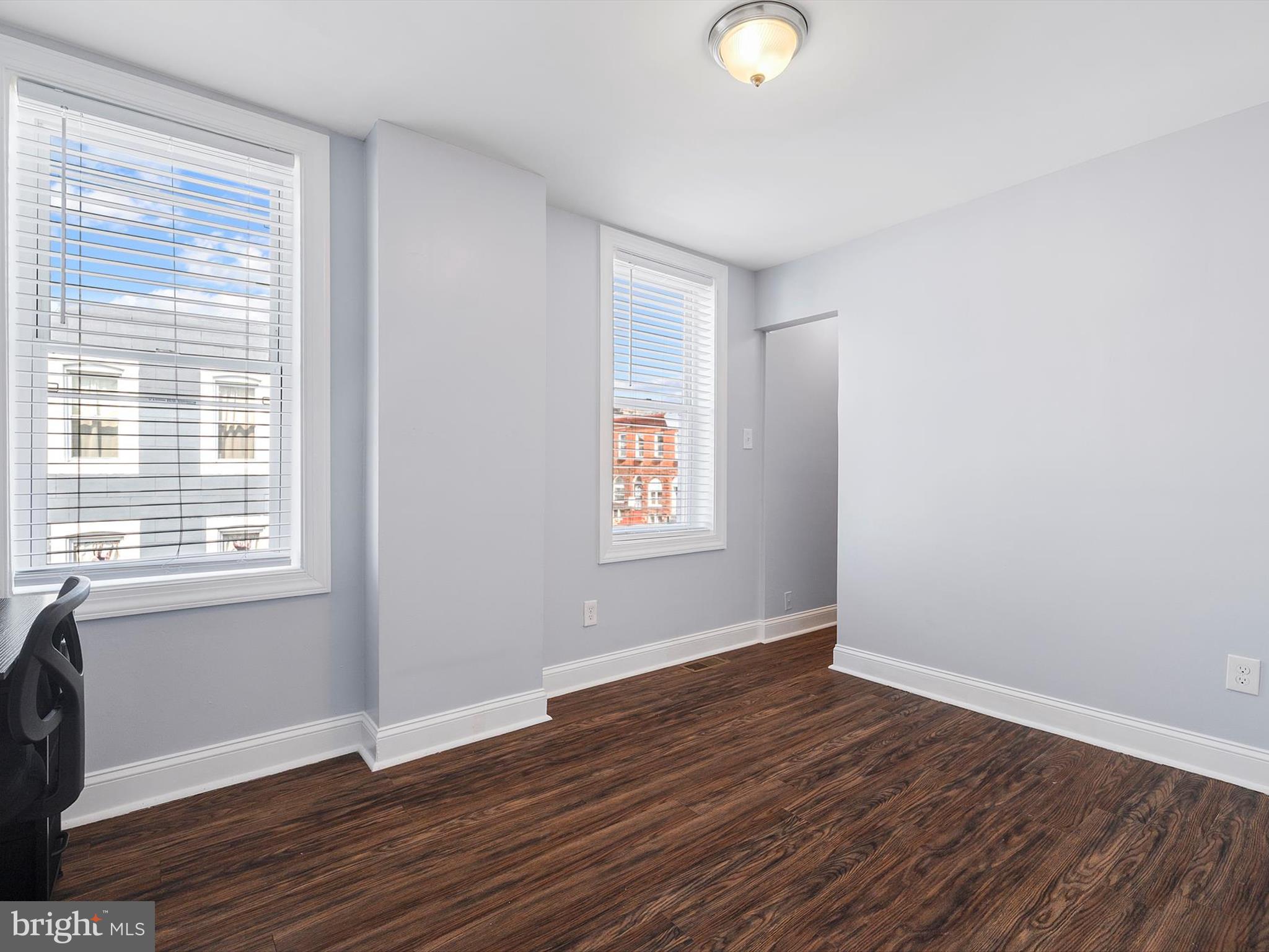 1713 East Lafayette Avenue Baltimore, MD 21213 - Photo 17 of 29 a view of an empty room with wooden floor and a window