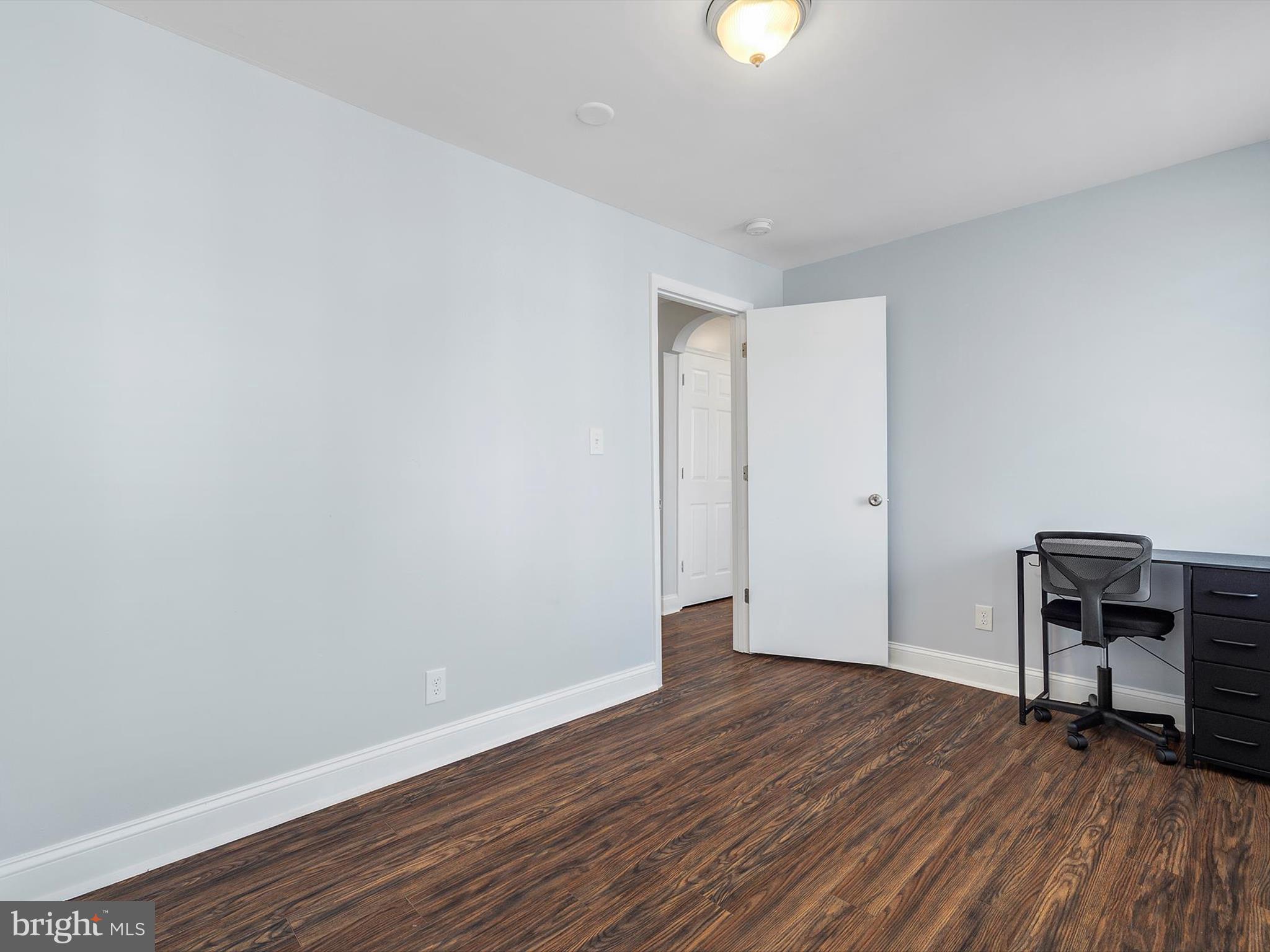 1713 East Lafayette Avenue Baltimore, MD 21213 - Photo 18 of 29 a big room with wooden floor and a window