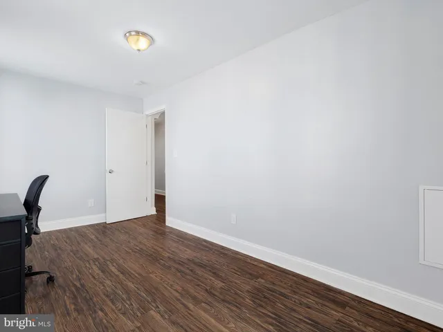 a view of a room with wooden floor and a sink