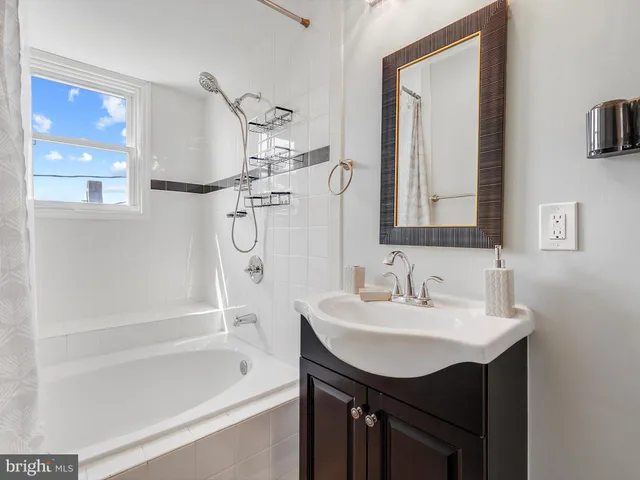 a bathroom with a sink mirror toilet and bathtub