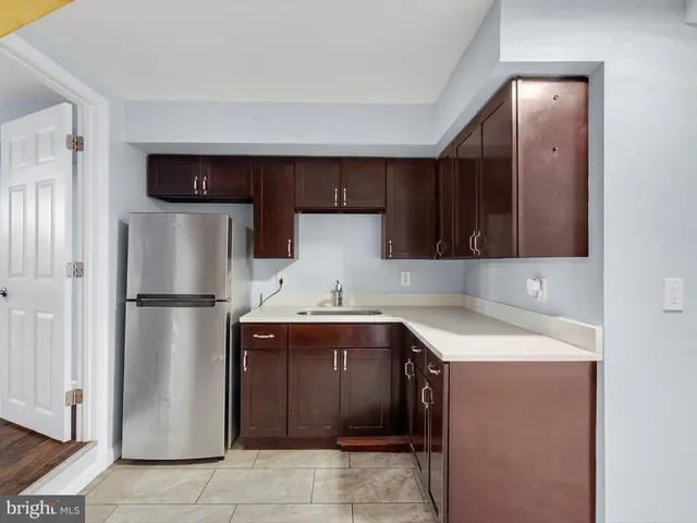 a kitchen with a sink a refrigerator and a stove