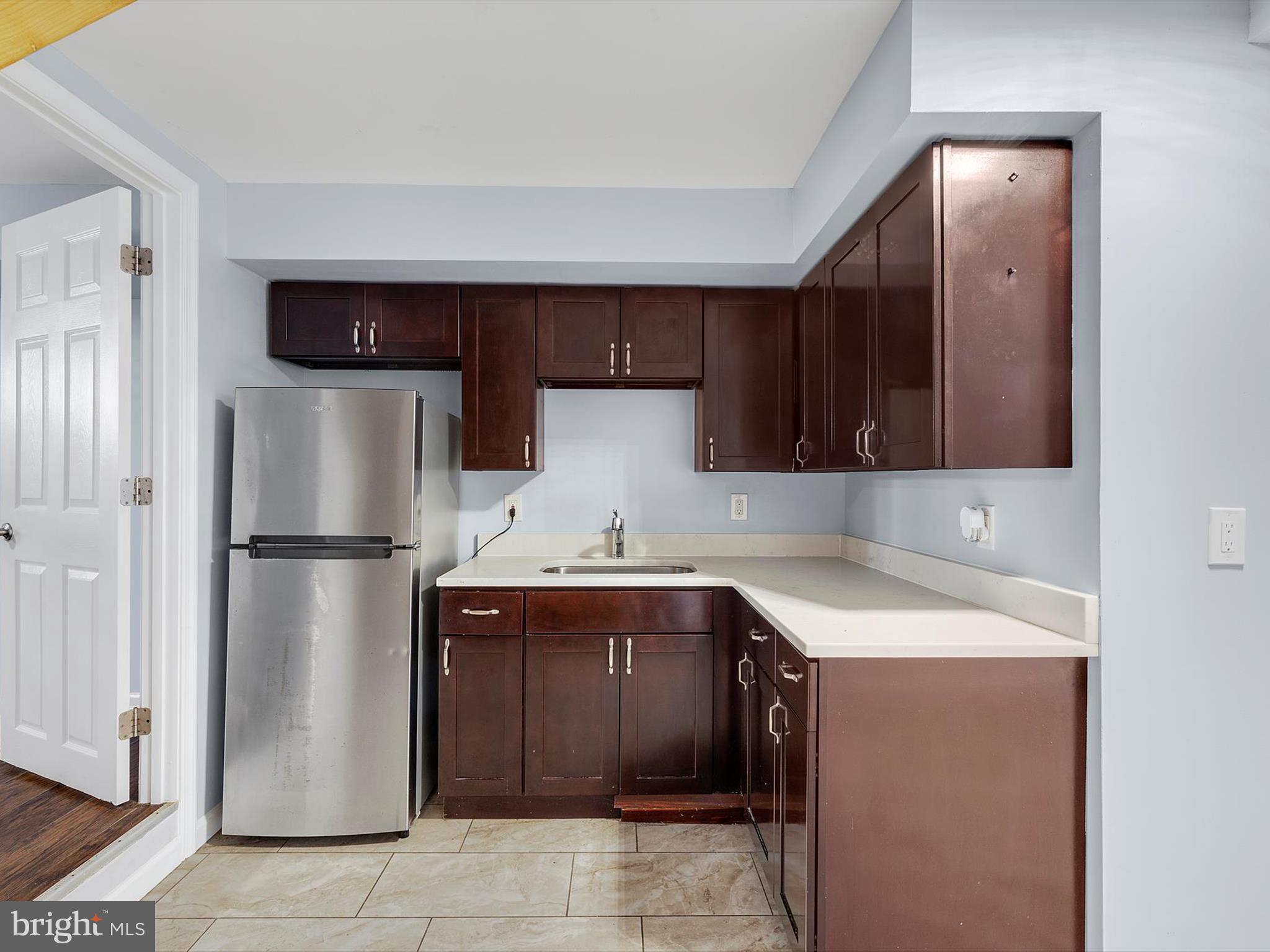 1713 East Lafayette Avenue Baltimore, MD 21213 - Photo 24 of 29 a kitchen with a sink a refrigerator and a stove
