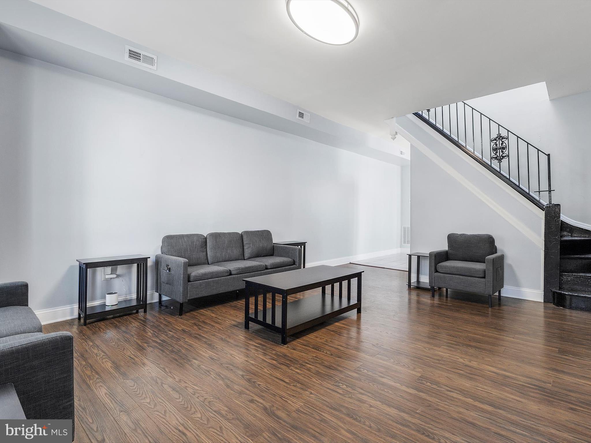 1713 East Lafayette Avenue Baltimore, MD 21213 - Photo 3 of 29 a living room with furniture and a wooden floor