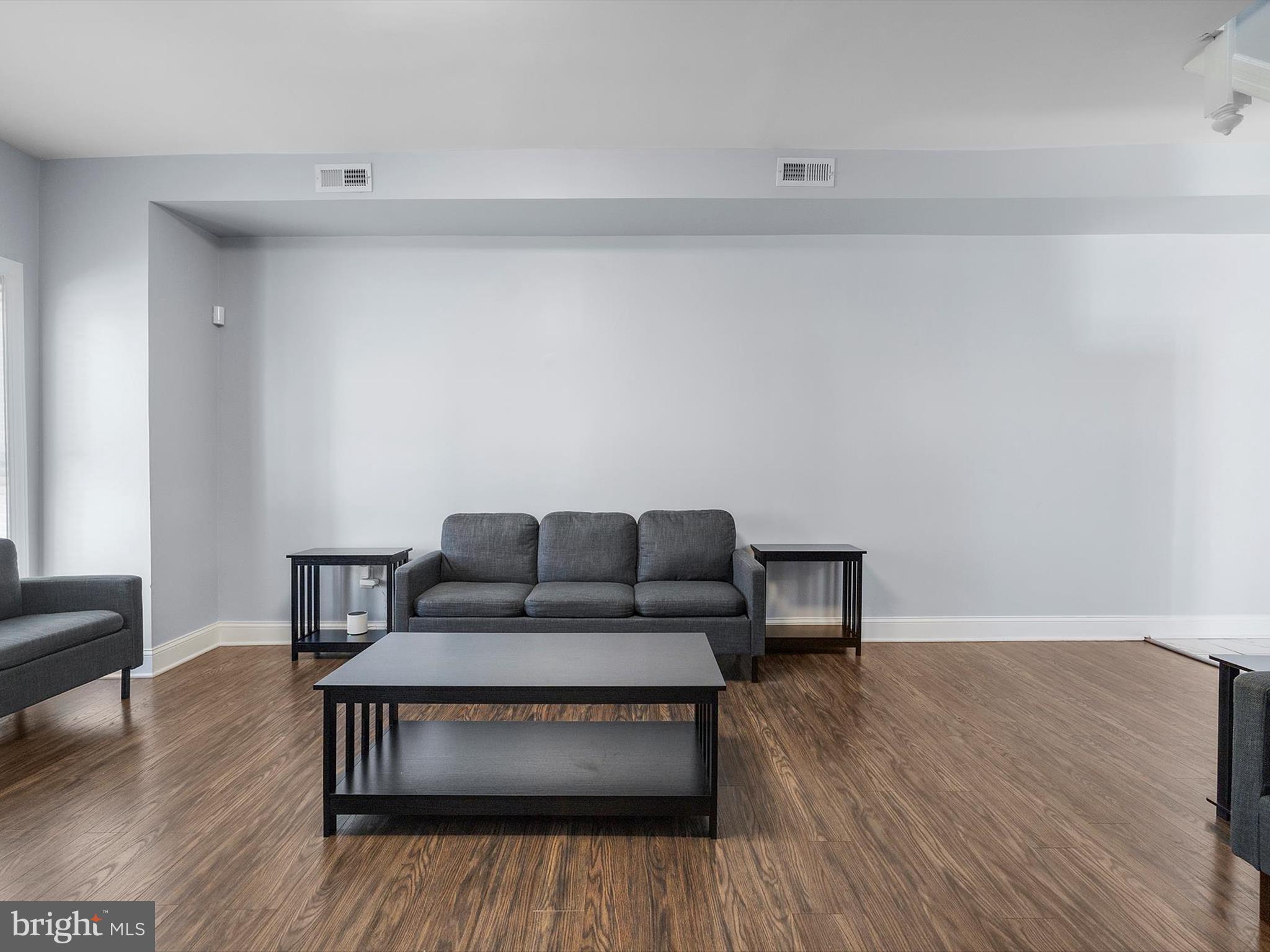 1713 East Lafayette Avenue Baltimore, MD 21213 - Photo 5 of 29 a living room with furniture and a wooden floor