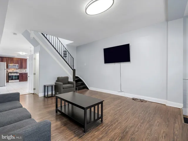 a living room with couches and a flat screen tv