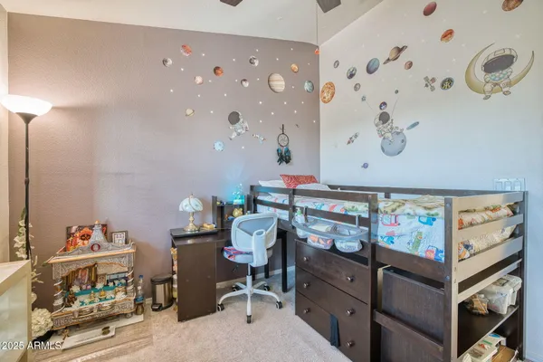 a room with furniture and baby crib