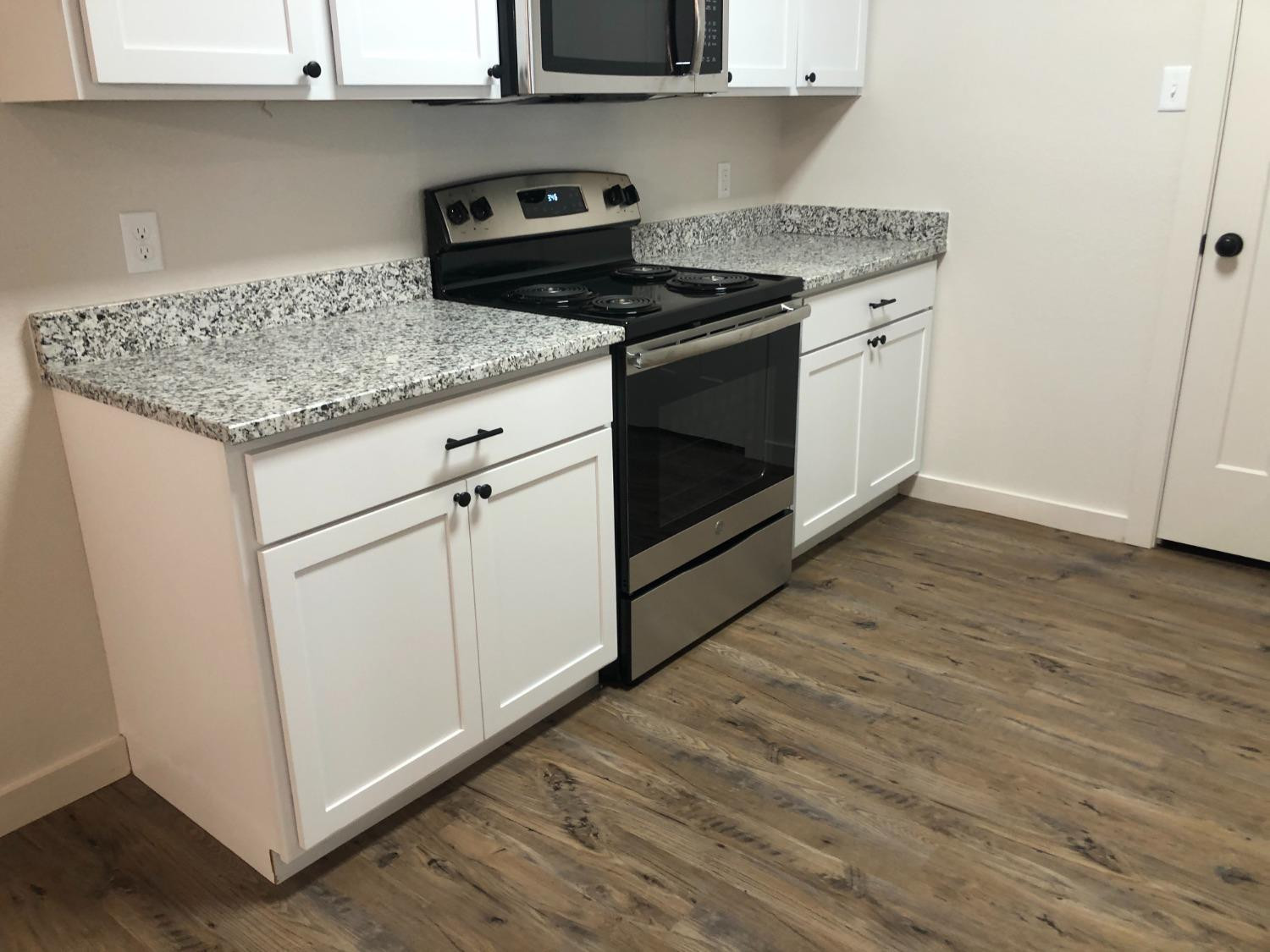 2723 137th Street Lubbock, TX 79423 - Photo 5 of 19 a kitchen with stainless steel appliances granite countertop a sink stove and cabinets
