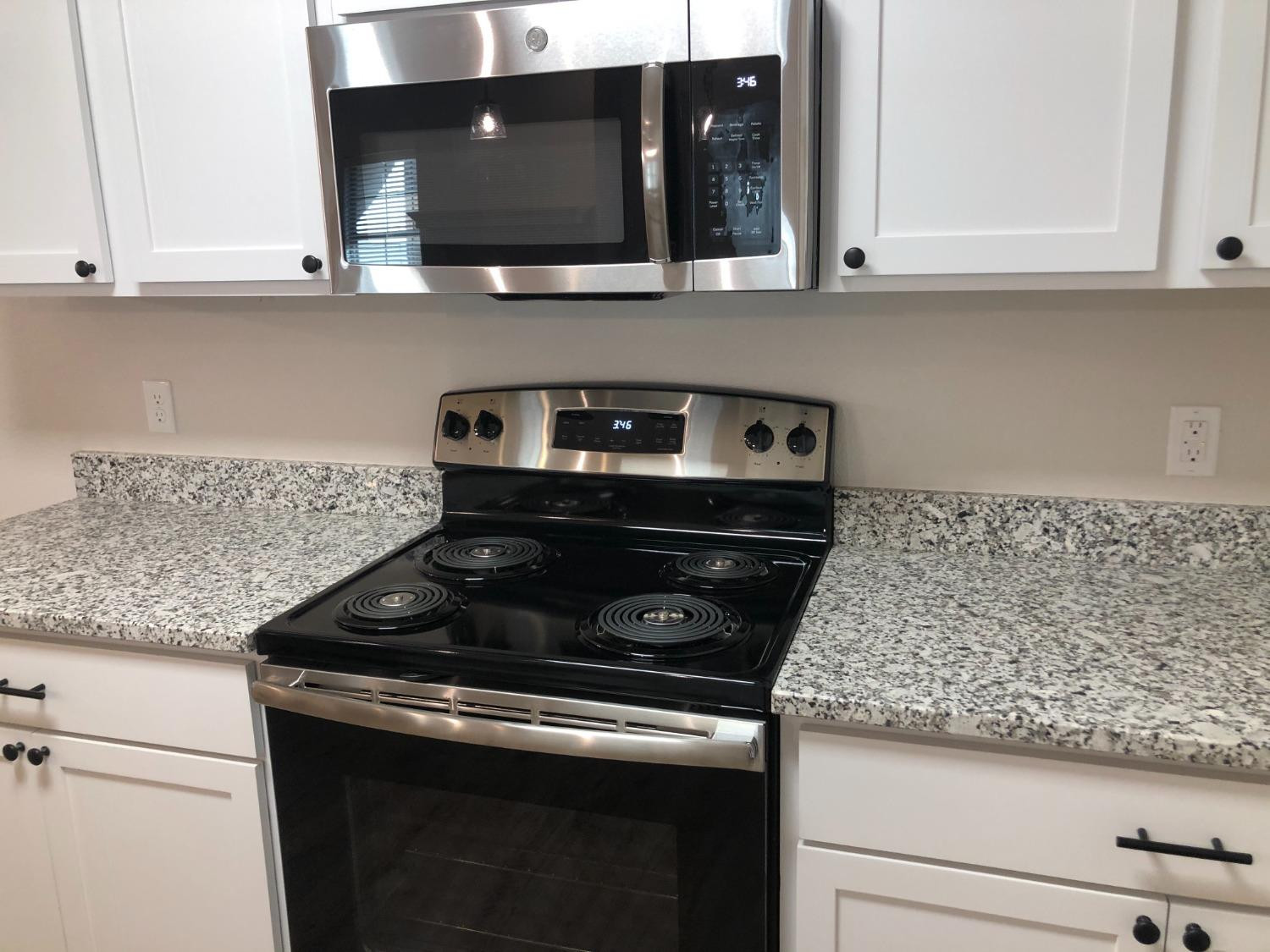 2723 137th Street Lubbock, TX 79423 - Photo 8 of 19 a kitchen with a stove and cabinets