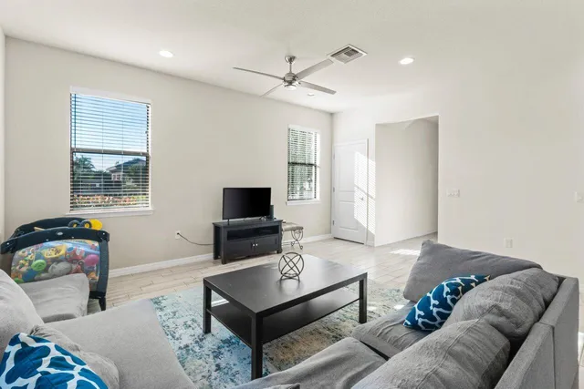 a living room with furniture and kitchen view