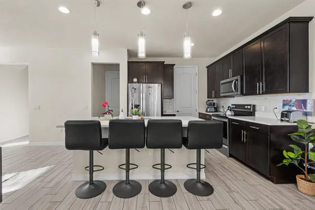 a kitchen with stainless steel appliances granite countertop a sink stove and cabinets