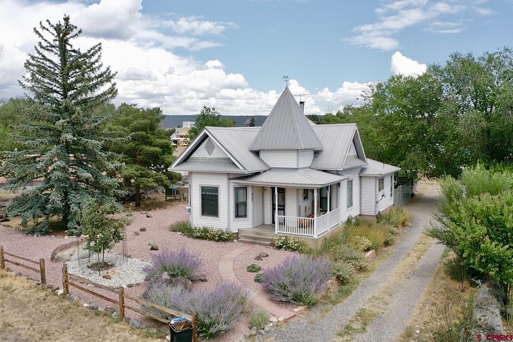 225 Northwest 4th Street Cedaredge, CO 81413 - Photo 4 of 44 a front view of a house with garden