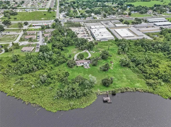 an aerial view of lake residential house with outdoor space and seating