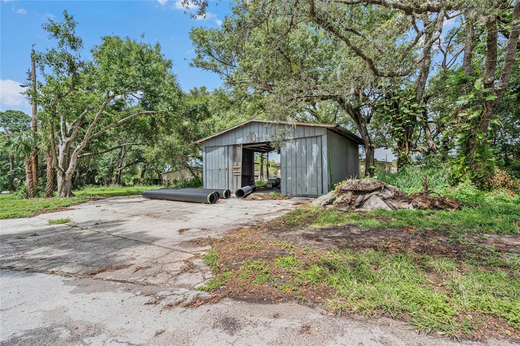 2000 Dundee Road Winter Haven, FL 33884 - Photo 7 of 35 a view of a house with a yard and large tree