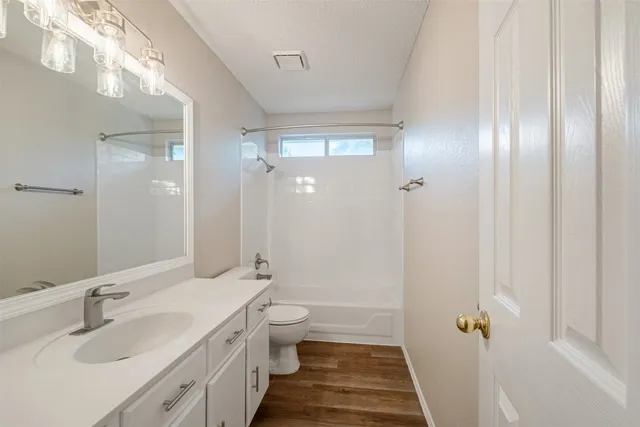 a bathroom with a double vanity sink toilet and shower