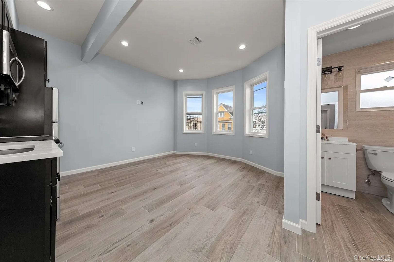32-17 105th Street, Unit 2F Queens, NY 11369 - Photo 2 of 4 a view of empty room with wooden floor and fan