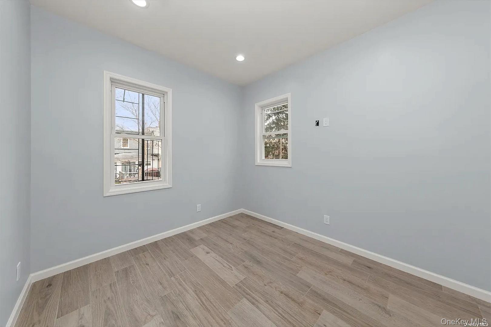 32-17 105th Street, Unit 2F Queens, NY 11369 - Photo 4 of 4 a view of empty room with wooden floor and fan