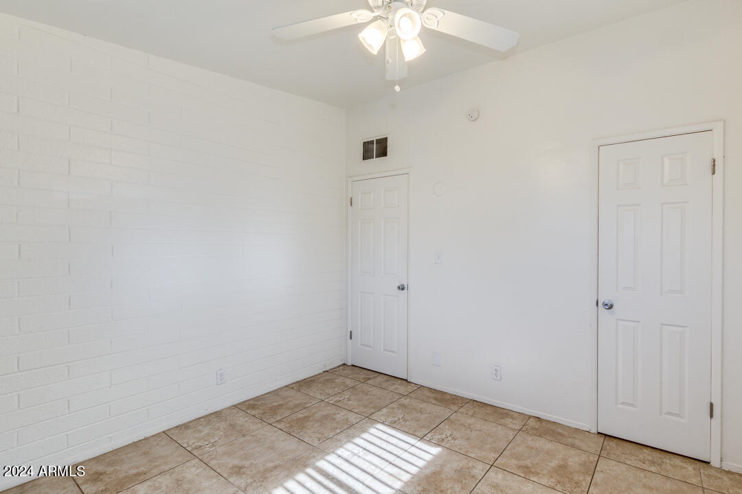 1921 East Virginia Avenue, Unit 14 Phoenix, AZ 85006 - Photo 13 of 20 an empty room with a chandelier fan
