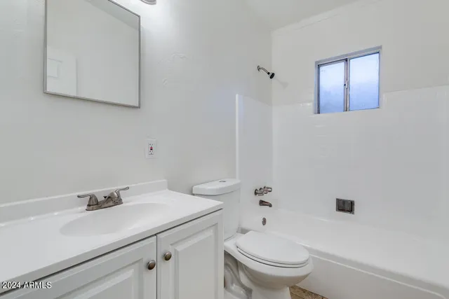a bathroom with a sink toilet and vanity