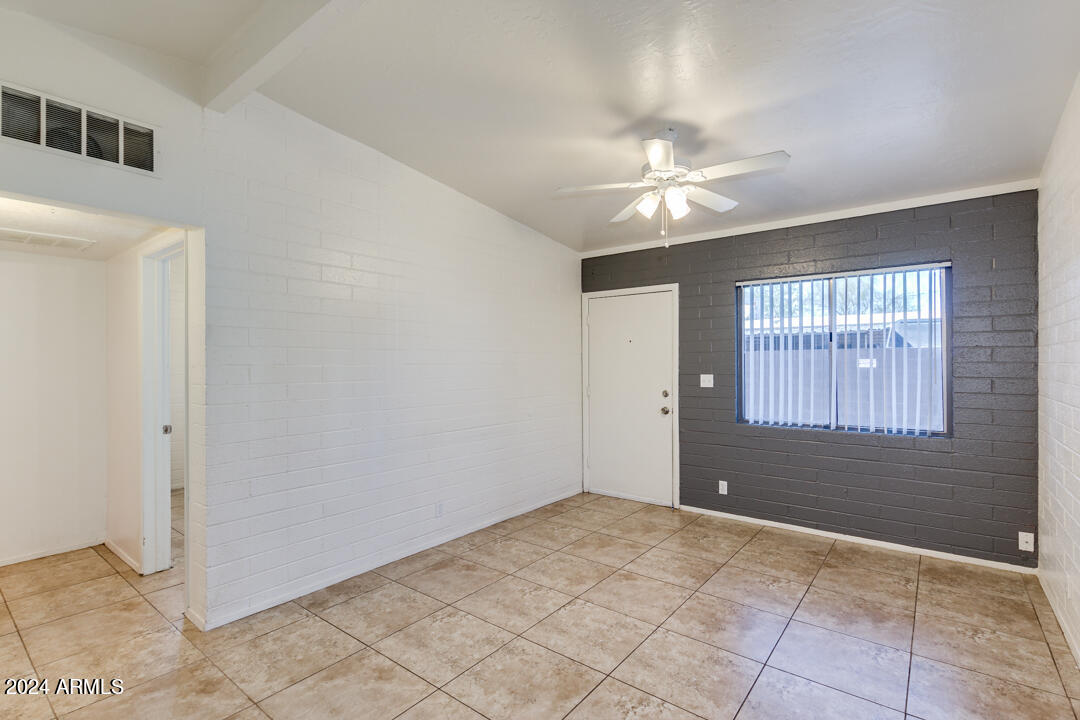 1921 East Virginia Avenue, Unit 14 Phoenix, AZ 85006 - Photo 5 of 20 a view of an empty room with a ceiling fan and windows