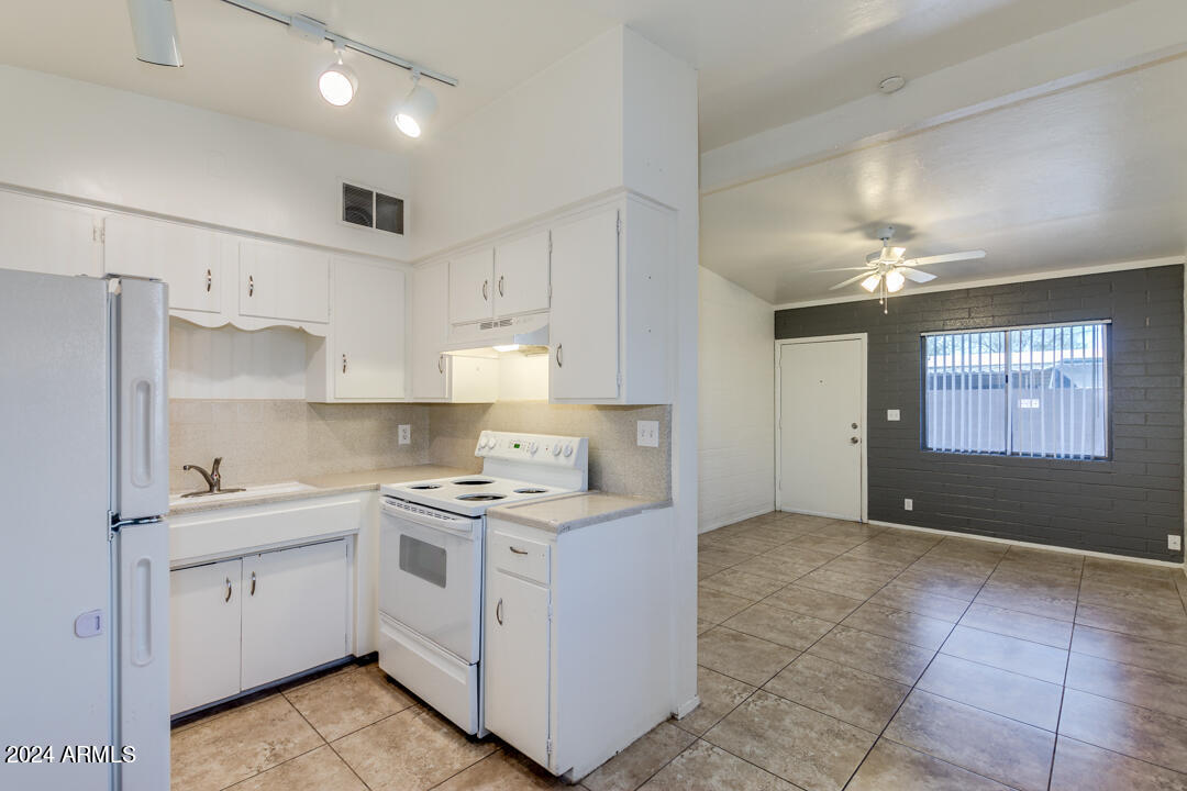1921 East Virginia Avenue, Unit 14 Phoenix, AZ 85006 - Photo 7 of 20 a kitchen with a stove a sink and a refrigerator