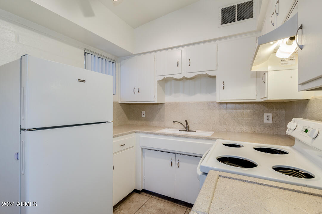 1921 East Virginia Avenue, Unit 14 Phoenix, AZ 85006 - Photo 8 of 20 a kitchen with a refrigerator sink and cabinets