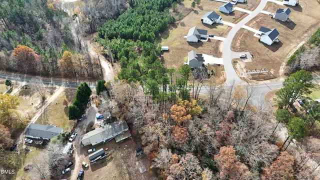 an aerial view of a house with yard