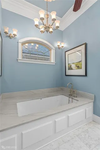 a bathroom with a sink a large mirror and a chandelier