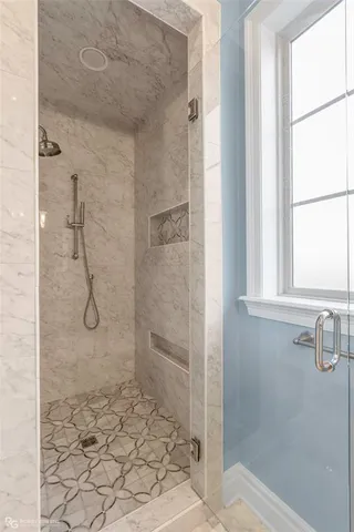 a bathroom with a glass shower door