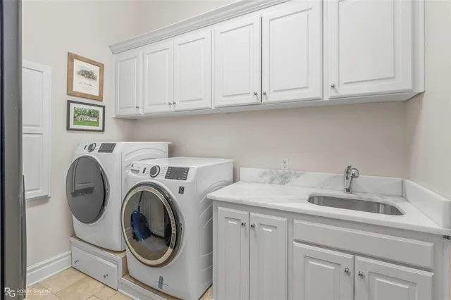 a utility room with sink dryer and washer