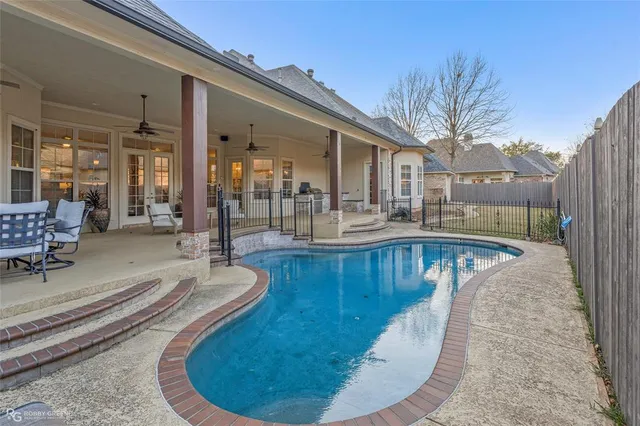 a view of a swimming pool with sitting area