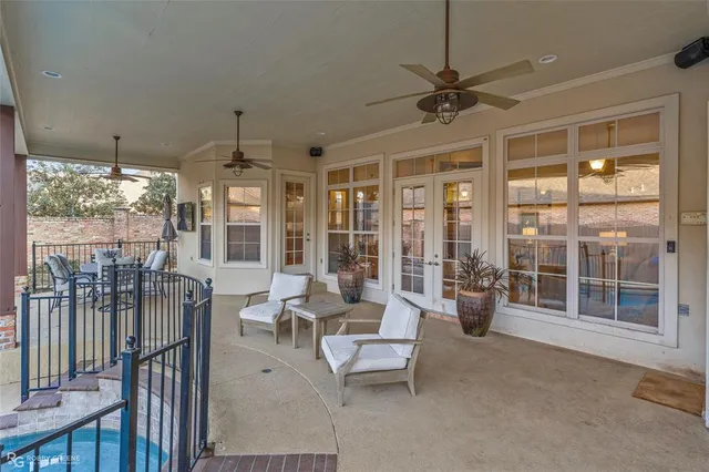 a living room with furniture and large windows