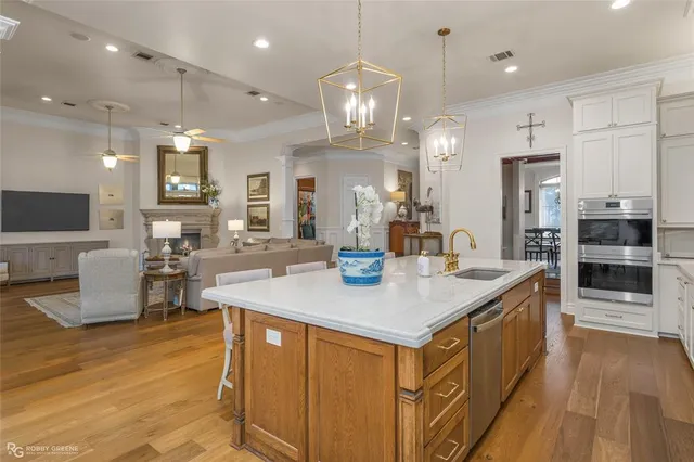a kitchen with kitchen island a large counter top appliances and cabinets