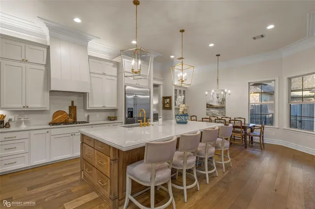 a large kitchen with a table and chairs