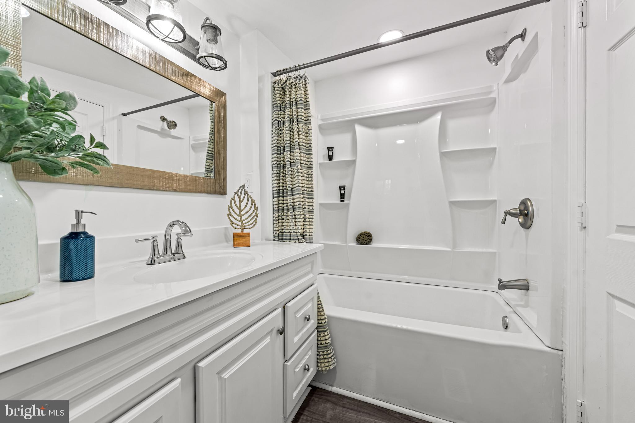 239 3rd Street Gloucester City, NJ 08030 - Photo 12 of 20 a bathroom with a granite countertop sink mirror toilet and bathtub