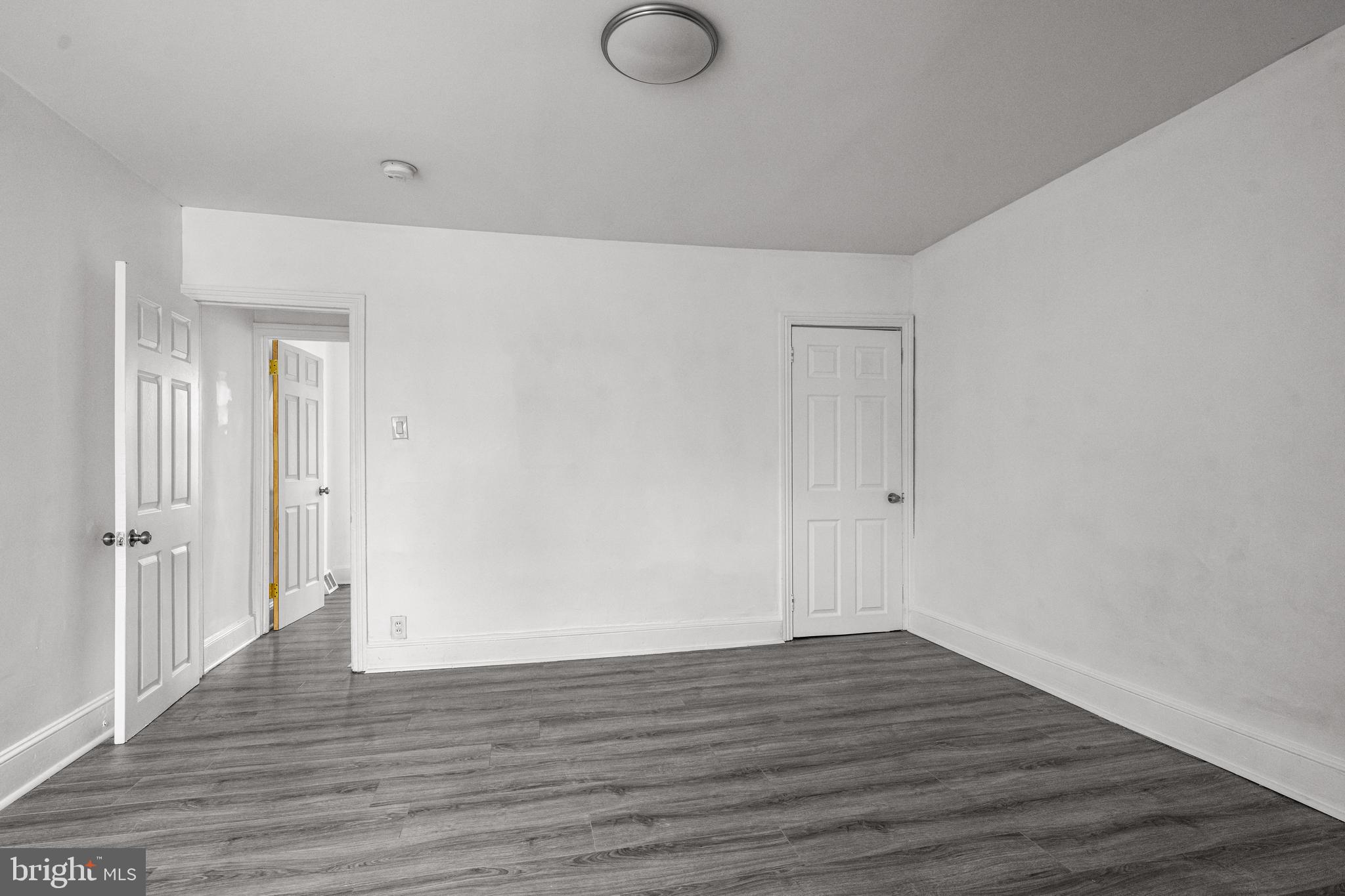 239 3rd Street Gloucester City, NJ 08030 - Photo 16 of 20 a view of an empty room with wooden floor